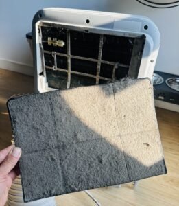 Dirty portable air conditioner filters showing heavy dust buildup